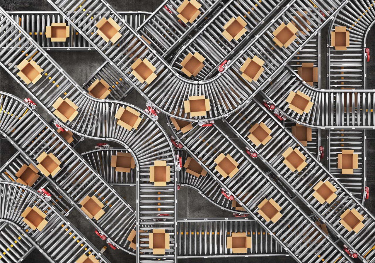 Top-down view of an automated conveyor system routing parcels through a sorting facility
